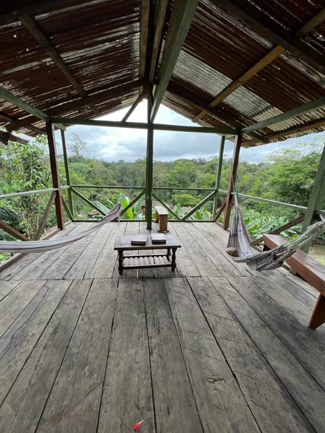 Wooden terrace with hammocks overlooking the Napo River