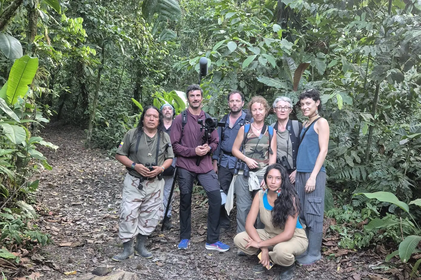 Group of visitors with camera gear on a rainforest trail