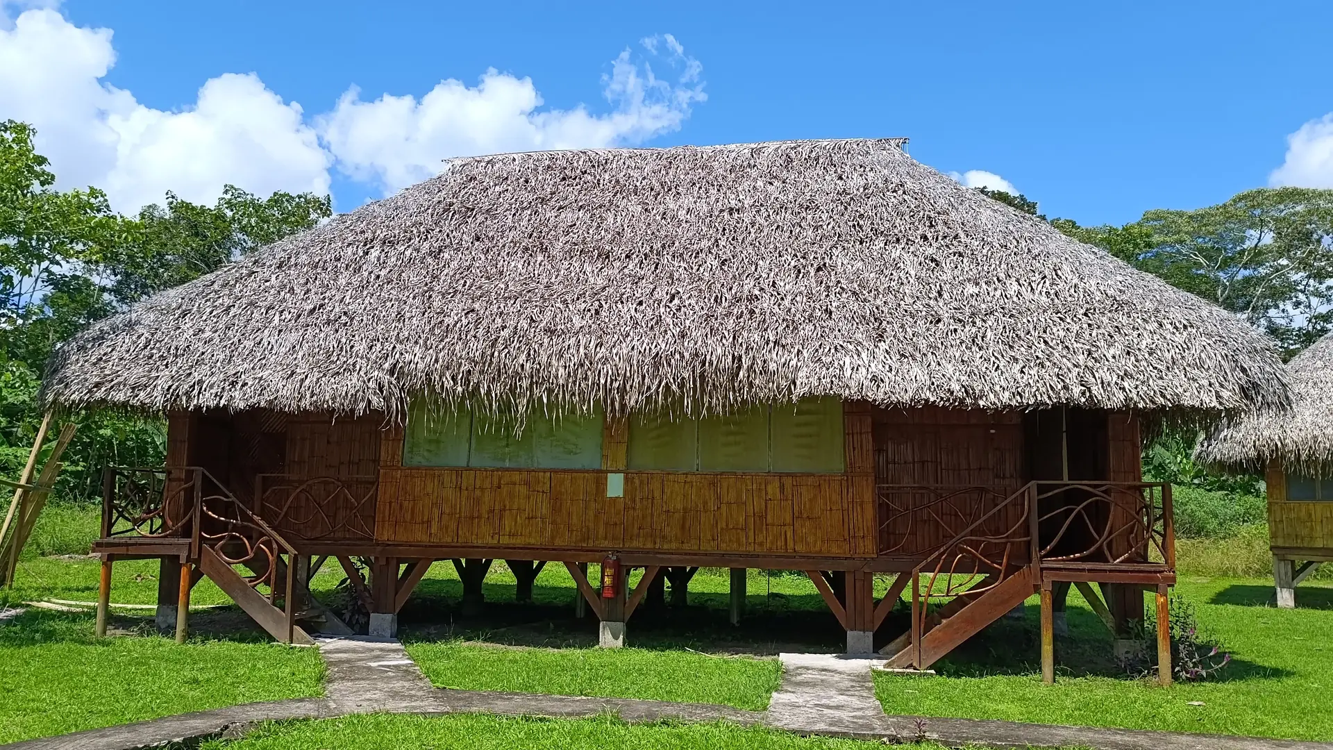 Cane cabins with thatched roofs on stilts in a clearing of the Amazon rainforest
